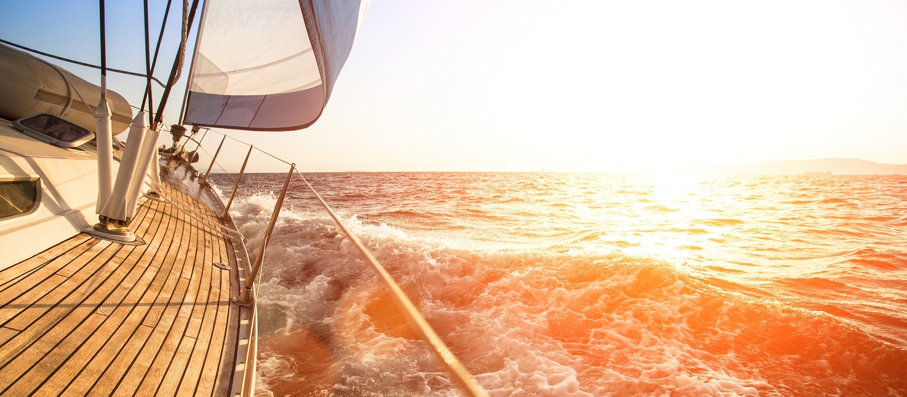 Sailing yacht against sunset. Luxury yachts.